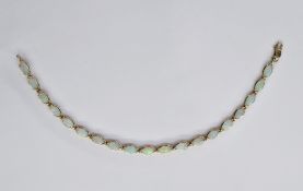 14ct yellow gold and opal line bracelet, comprising 19 opals of elliptical shape, each approx 6.