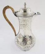 George III silver hot water jug, makers mark IS, London 1778, with later floral decoration and