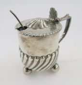 Victorian silver lidded mustard pot, circular half gadrooned body on three bun feet, with blue glass