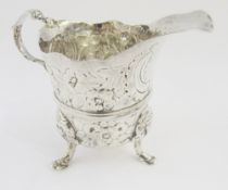 Silver cream jug, possibly Irish 18th century, makers mark II, with central girdle raised and mask