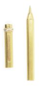 Les Must de Cartier stylos ball point pen, in a ribbed gold plated case, 13.2cm long, with booklet