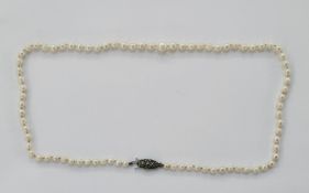 Graduated string of cultured pearls on silver marcasite set clasp, made by Lotus, princess length,