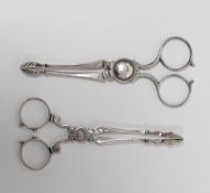 Two sets of Georgian silver scissor action sugar nips, each marked with the lion passant, one makers