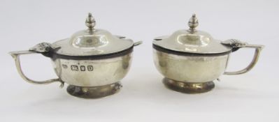 Pair George V silver lidded mustard pots, with blue glass liners, hallmarked London 1939 by