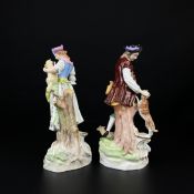 A pair of early 20th century Dresden porcelain figure groups depicting a man with a dog and lamb,