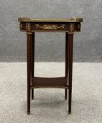 A French Empire style mahogany occasional or lamp table having a marquetry inlaid lobed top with a