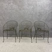 A set of three vintage French style wrought iron and wire work garden tub chairs each with a