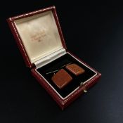 A pair of 20th century silver and red granite cufflinks in an Armour Winston of Burlington Arcade