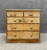 A Victorian pine chest of drawers having a thumb moulded top above two short over three long
