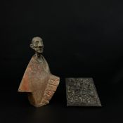 A cold painted and patinated bronze figure of a man in a shawl along with a bronze relief plaque