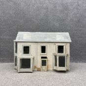 A 20th century scratch built and painted Georgian style doll's house along with a collection of