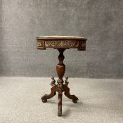 A French style mahogany occasional or lamp table having an inset circular marble top over a brass
