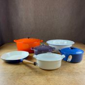 A collection of six pieces of kitchenware to include four cast iron Le Creuset casserole dishes with