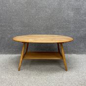 A mid-century oval beech and elm Ercol coffee table, model 454. H.44 W.99 D.83cm