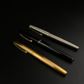 A collection of three pens to include a faceted black Waterman Concorde fountain pen with an 18k