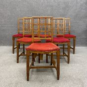 A set of six C.1900 Cotswold School style oak dining chairs each having a gridded lattice work