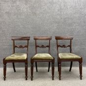 A set of three William IV mahogany dining chairs each having a curved top-rail above a carved