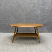 A mid-century oval beech and elm Ercol coffee table, model 454. H.44 W.99 D.83cm