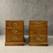 A pair of brass bound campaign style camphorwood bedside chests or side cabinets of three short