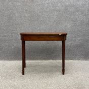 A George III crossbanded mahogany foldover demi lune card table with a baize lined top on square