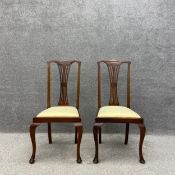 A pair of 19th century mahogany dining chairs each having a shaped top rail above a pierced