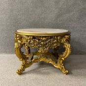 A 20th century continental Rococo style low table having a circular blush ivory marble top set