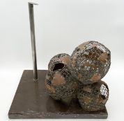 An abstract constructivist style metal and wire sculpture on a slate base by Robert De Quin. H.40