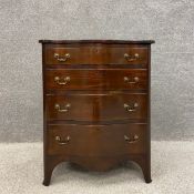 A small Georgian style mahogany serpentine chest of four graduating drawers with brass handles and