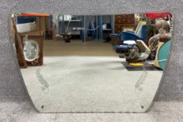 A mid to late 20th century mirror with etched foliate decoration on a clear glass surround. H.85 W.
