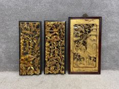 A pair of profusely carved Chinese giltwood openwork panels depicting birds among blossoming