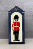 A child's sentry box cabinet with a hand painted image of a Royal Guard standing to attention. H.154