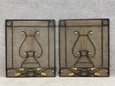 A pair of early 20th century wrought iron grilles each having a shaped pediment with overlapping