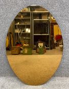 A vintage peach glass wall mirror. H.112 W.77.5cm