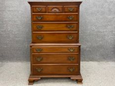 A Georgian style mahogany chest on chest with a moulded cornice above four long graduating drawers