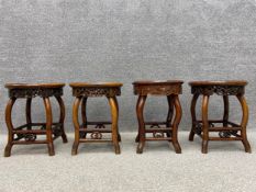 A set of four early 20th century style Chinese hardwood stools each having an inset white marble top