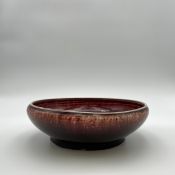 A Chinese late 18th/early 19th century Qing dynasty flambe glazed sang de boeuf ceramic dish with