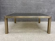 A 1970's vintage chrome and brass coffee table with smoked plate glass top. H.34.5 W.86 D.84cm (Some