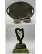 Three pieces of pewter to include a twin handled tray, sugar pot, and creamer by Unity Pewter with