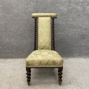 A late 19th century mahogany framed prie-dieu kneeler chair with a damask upholstered top rail, back