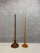 An early 20th century turned and carved mahogany standard lamp on a moulded pedestal base raised