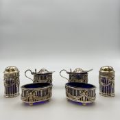 A collection of early 20th century hallmarked silver and blue glass lined Mappin & Webb condiment