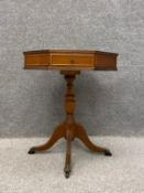 A Regency style octagonal mahogany drum table inset with a tooled and gilt leather top over a single