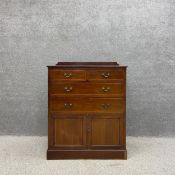 An Edwardian mahogany low linen press or half dresser with a shaped gallery back over a