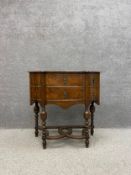 An early 20th century William and Mary style serpentine fronted walnut side table having a shaped