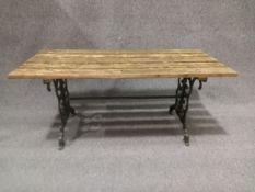 A contemporary painted cast iron garden table in the 19th century style with scrolling openwork