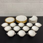 A matched part dinner service to include twelve Wedgwood dinner plates and twelve twin handled