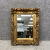 A contemporary antique style carved giltwood mirror with scrolling shell and acanthus leaf