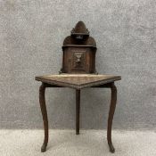 A late 19th century oak corner table having a shaped and stepped waterfall superstructure of two