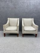 A pair of Georgian style George Smith armchairs with curved armrests upholstered in a cream tweed