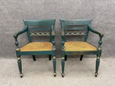 A pair of late 19th/early 20th century Regency style painted carver chairs each with a scrolling top